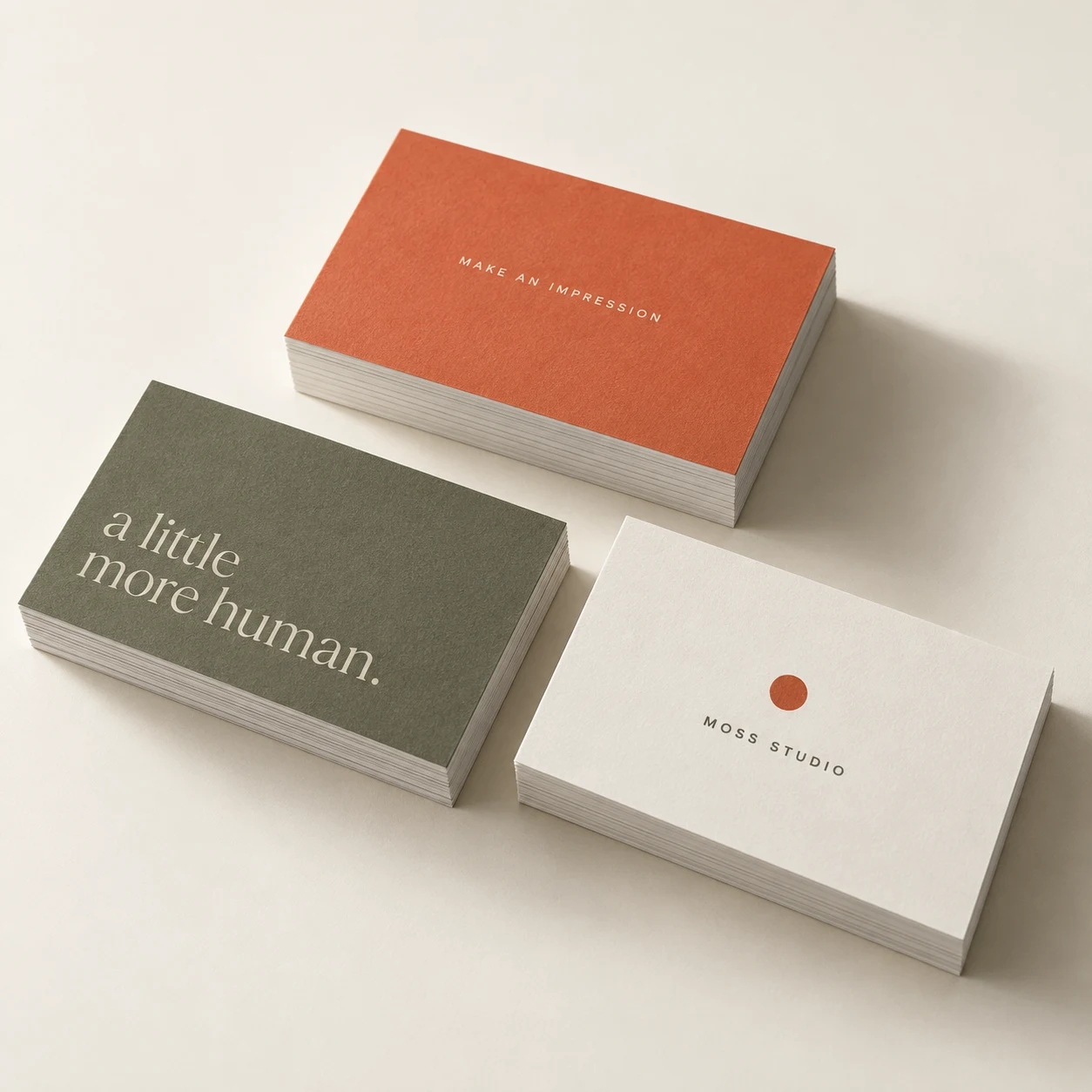 Olive, warm white and vermilion soft touch business card concept, arranged in three stacks