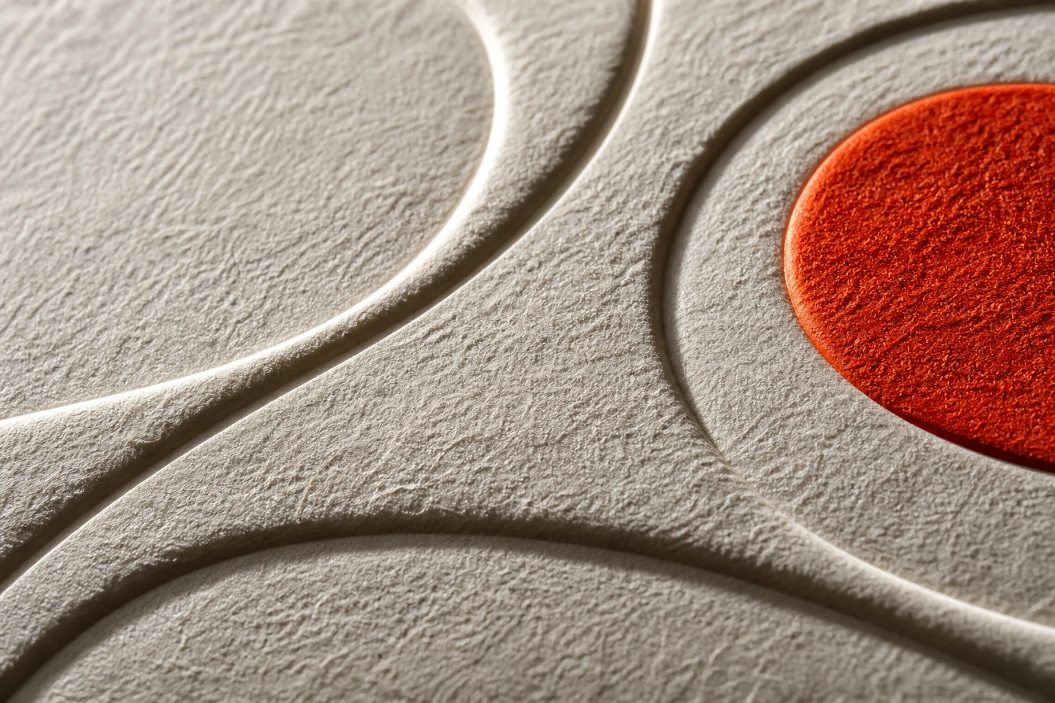 Deeply sculpted cotton paper with a vivid vermilion detail