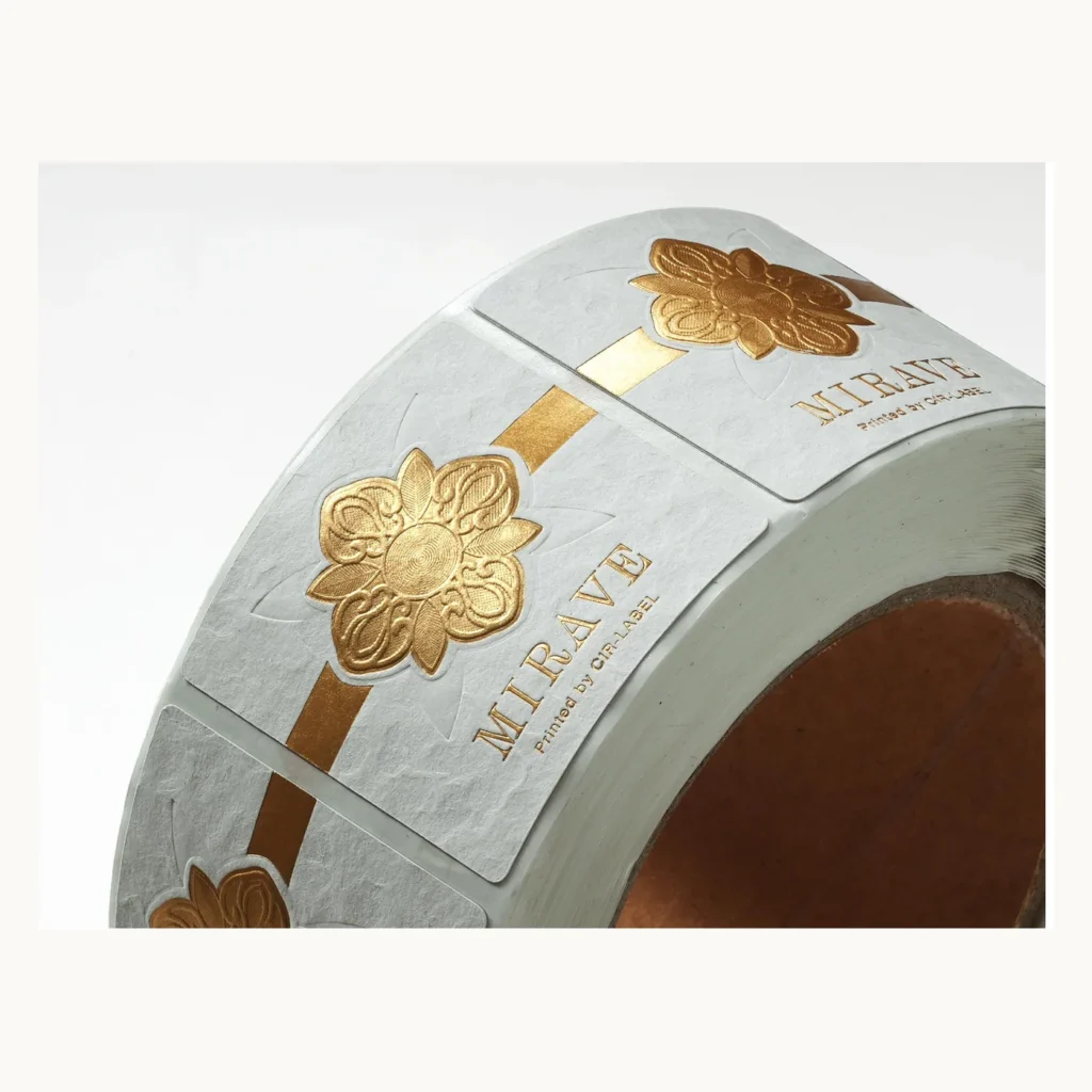 Photograph of White Floral Labels with Sculpted Gold Motif