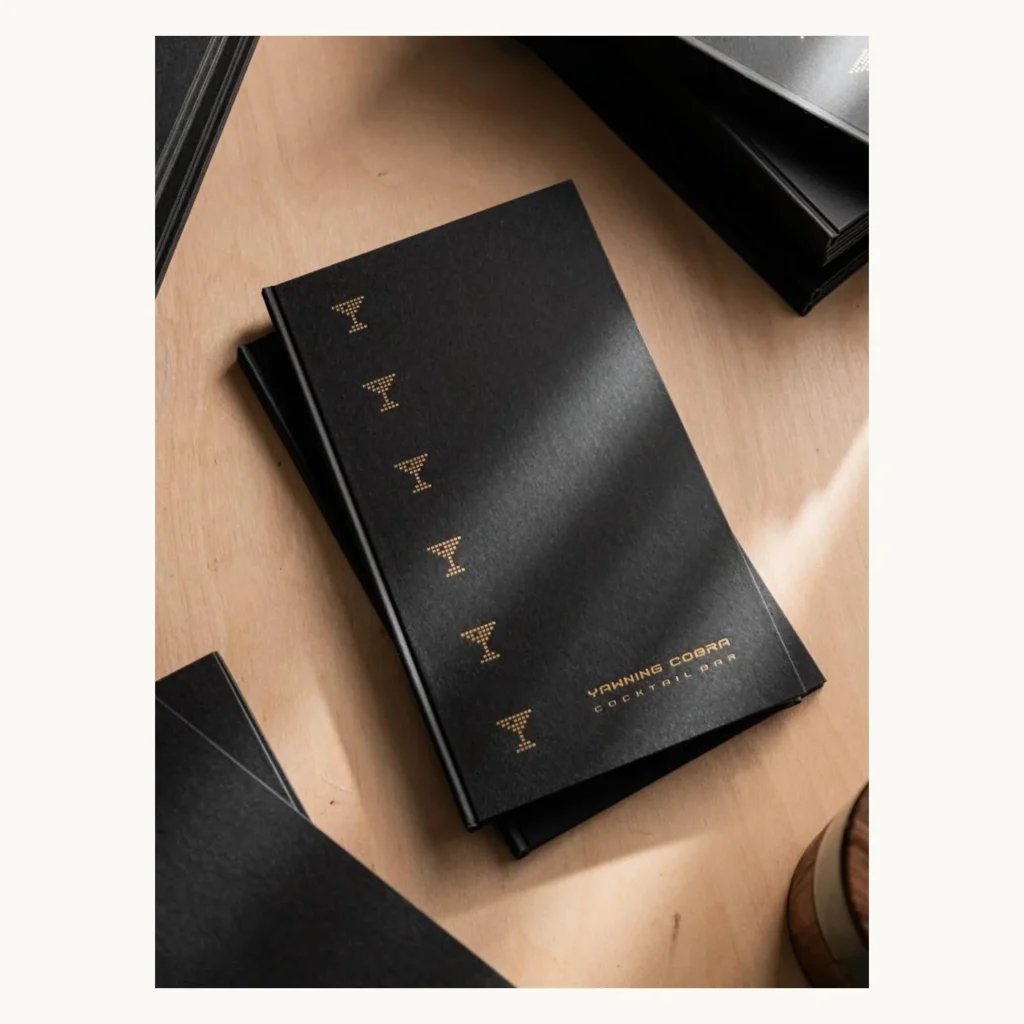 Photograph of Black Cotton Paper Cocktail Bar Menus with Gold Foil