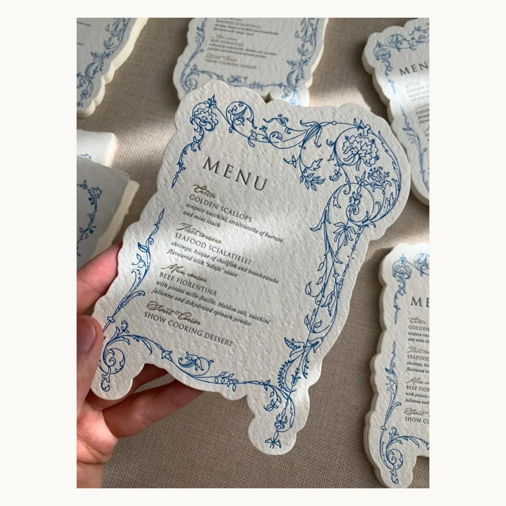 Photograph of Blue Vow Card and Die-Cut Wedding Menu Suite