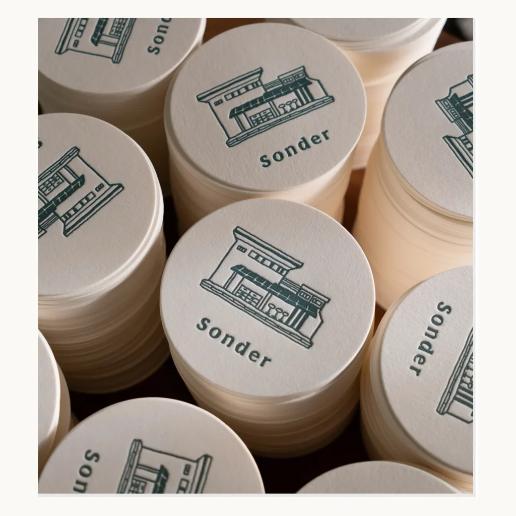 Photograph of Green Line-Art Coffee Coasters on Washed Paper