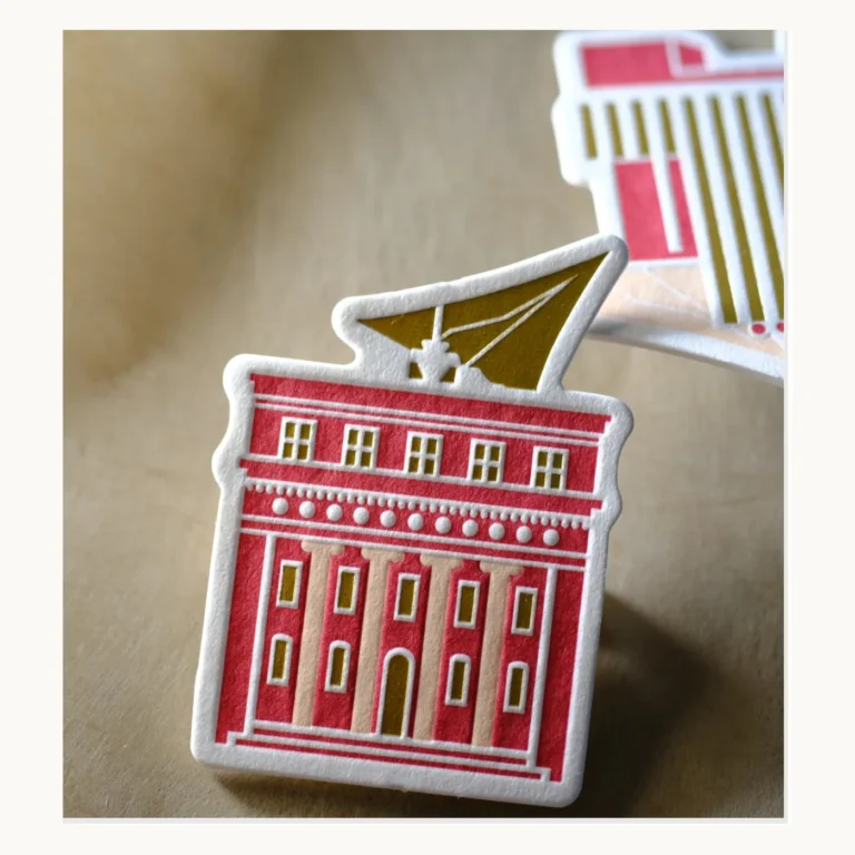 Photograph of Red Building Letterpress Paper Badges with Foil Detail
