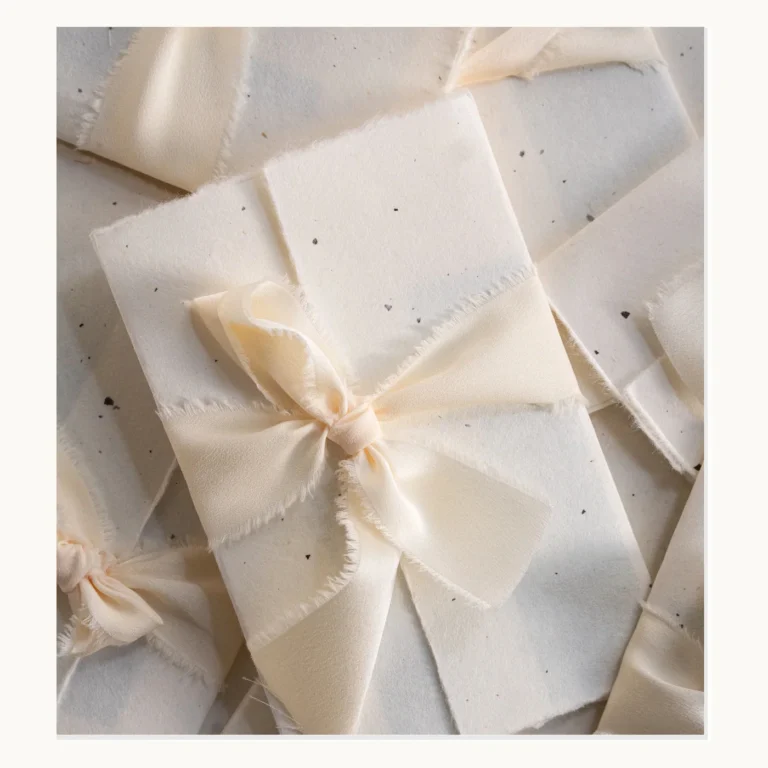 Photograph of Ribbon-Wrapped Deckle-Edge Wedding Invitation Sets