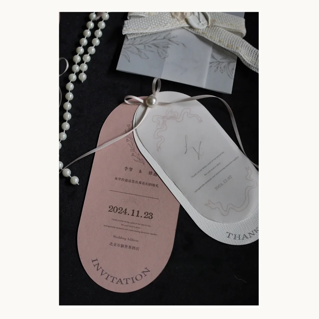 Photograph of Blush Oval Wedding Invitation Cards