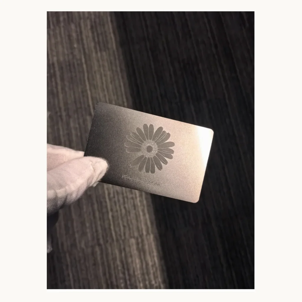 Photograph of Dark Metal Card with Floral Emblem