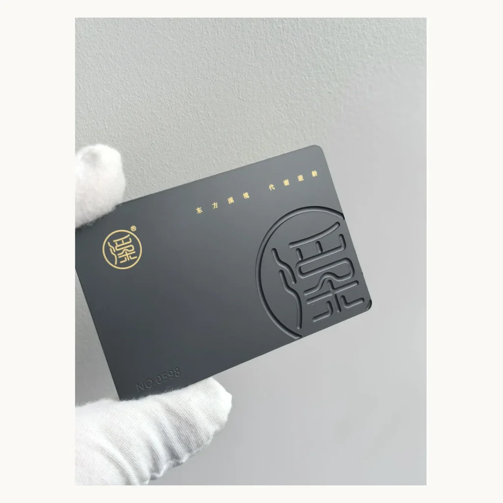 Photograph of Charcoal Metal Card with Raised Circular Monogram