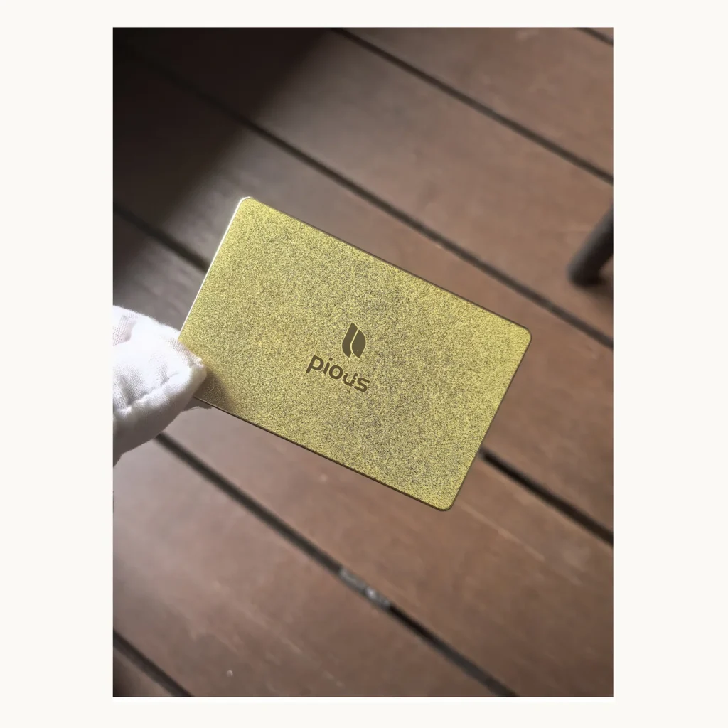 Photograph of Pious Gold-Textured Metal Card