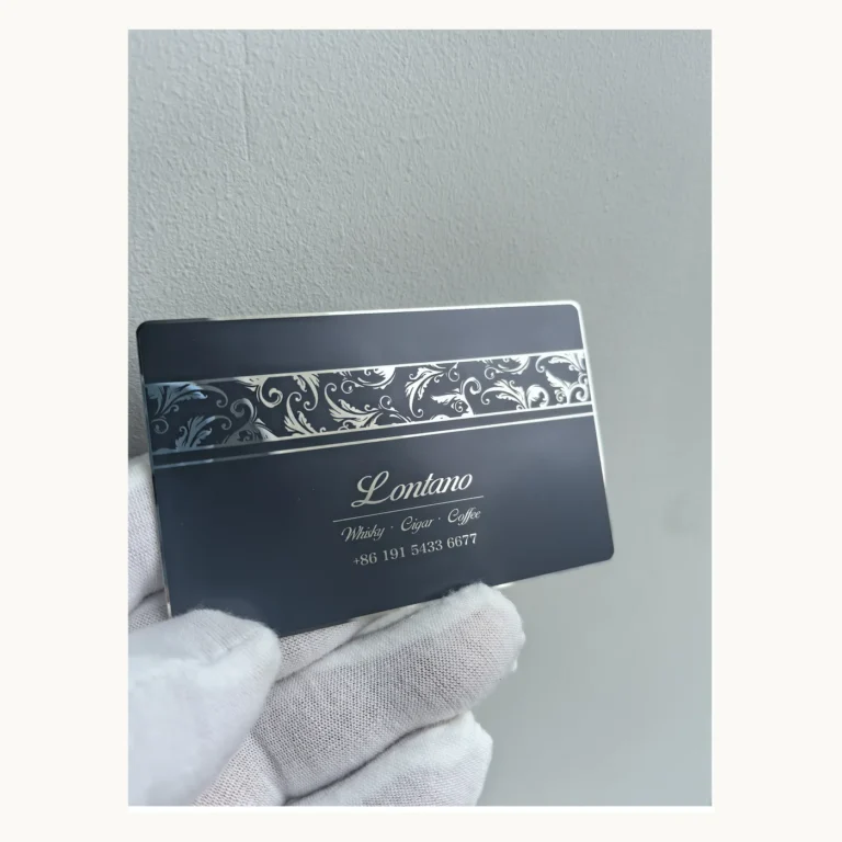 Photograph of Black Lontano Metal Contact Card with Silver Scrollwork