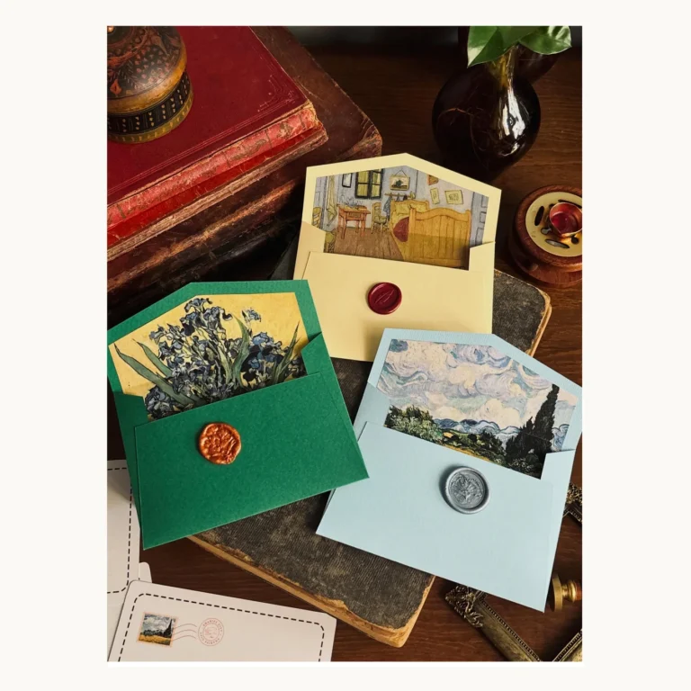 Photograph of Painterly Wedding Invitation Envelopes in Green and Gold